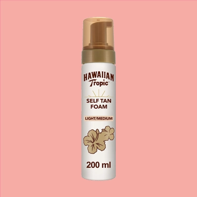 Hawaiian Tropic Self Tanning Foam Light/Medium 200ml Bottle - a skincare product that provides a natural-looking tan. The cream and brown-colored bottle has a blue and orange label with the product name and key ingredients. The foam is visible through the bottle, and a pump dispenser is on top.