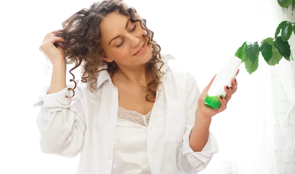 A mature woman holding a bottle of sulfate-free shampoo, epitomising the Sulfate-Free Hair Care movement in Australia.