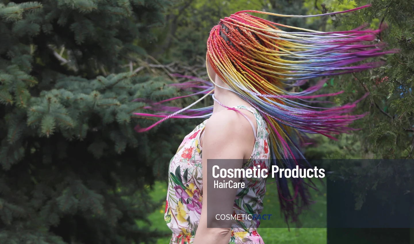 A woman with vibrant, fantasy hair dye dancing joyfully.