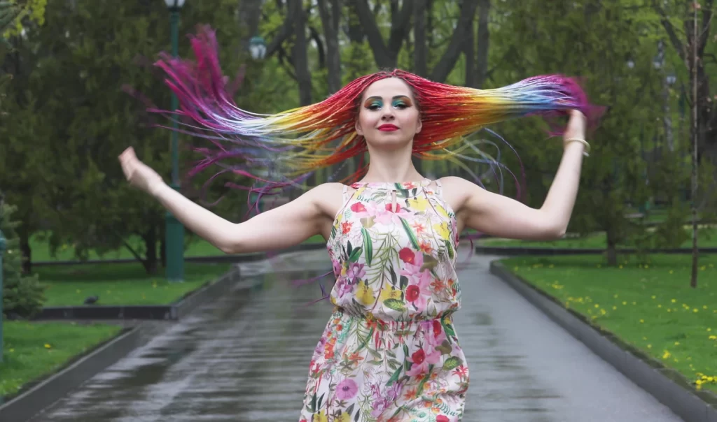 A stunning woman showcasing her vibrant, bold hair colour, epitomising the hair trend discussed in the article