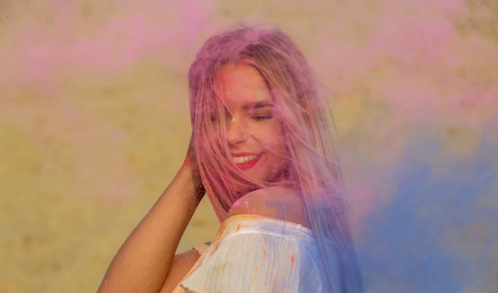 A beautiful woman with ombre hair enjoying the rain, perfectly illustrating the Ombre Hair Australia trend