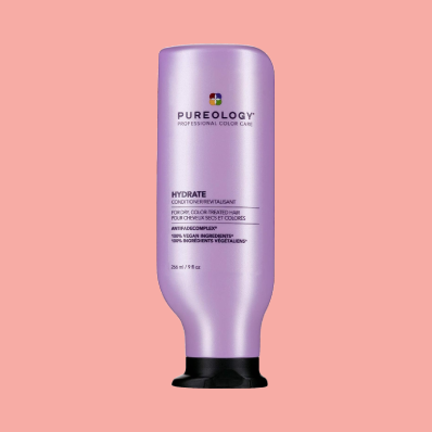 Woman combing her Frizzy Curly Hair with Pureology Hydrate Conditioner