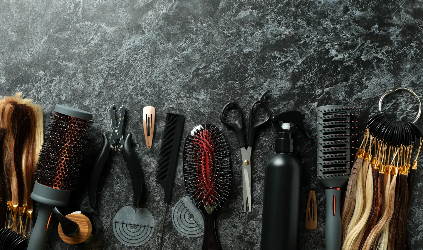 Collection of hair accessories, including headbands, hair ties, hair clips, scrunchies, hairbands, hairpins, hair combs, styling clips, hairbands with teeth, and bobby pins, on a black marble background.