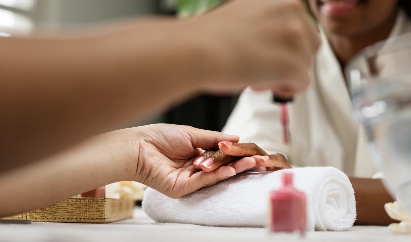 DIY Gel Nails - Image of a woman in a spa salon, enjoying a therapy treatment while getting her nails painted.