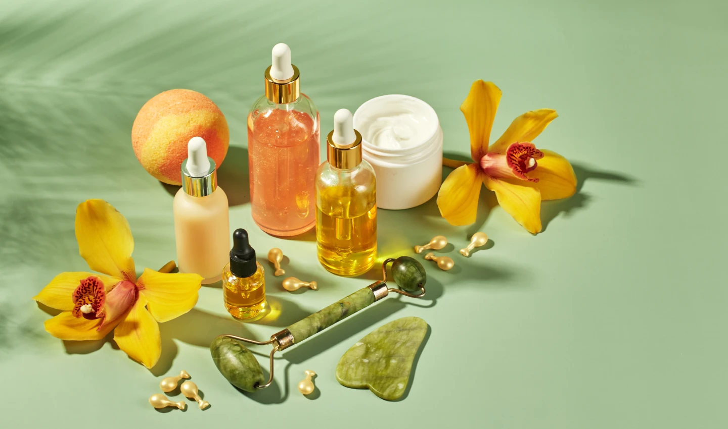 Bottles of vitamin-enriched skincare serums and creams on a light background