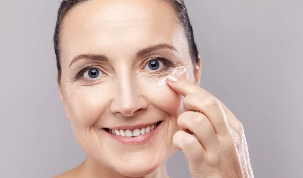 Woman applying Instant Eye Lift Cream to her face for rejuvenation