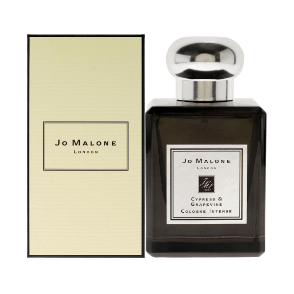 Elegant bottle of Jo Malone's Cypress & Grapevine Cologne Intense against a serene woodland backdrop