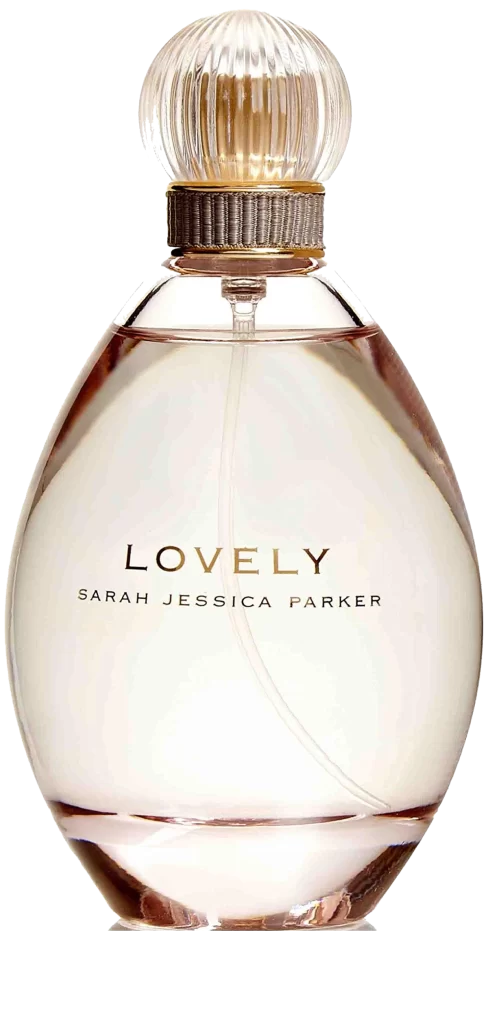 Close-up of a Sarah Jessica Parker Lovely perfume bottle on a chic vanity table, accented by soft lighting and floral decor.