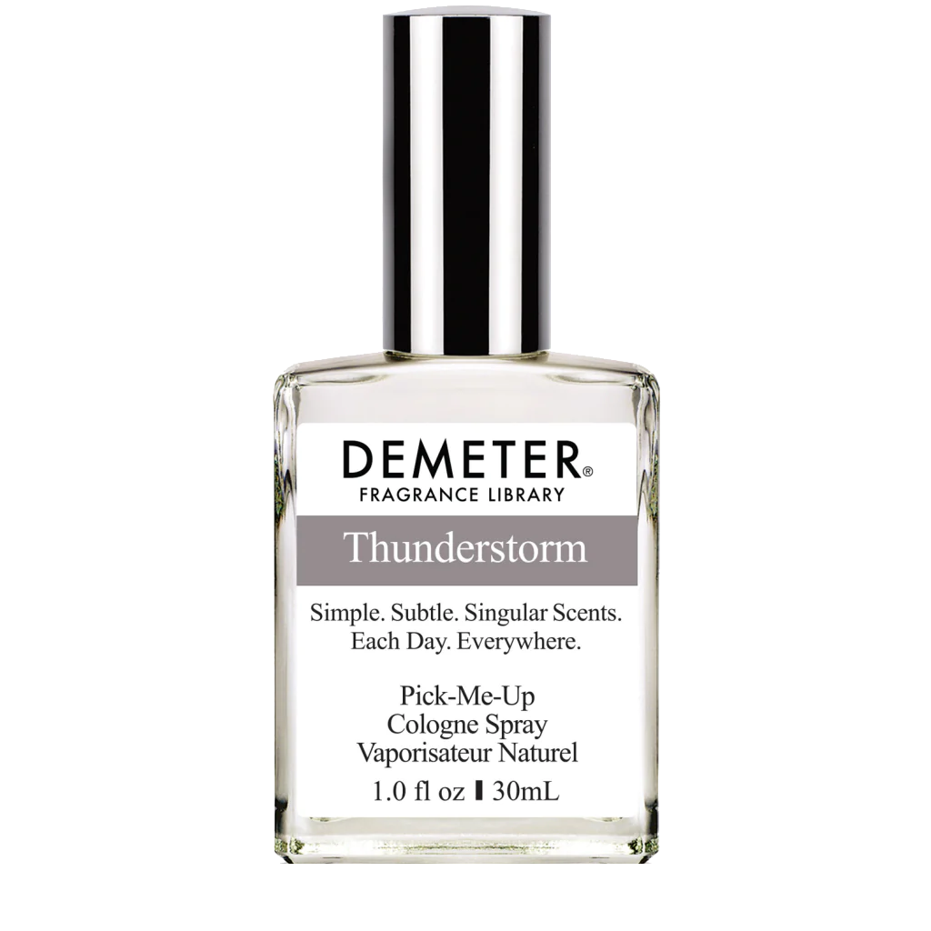 ThunderstormCologneSpray bottle elegantly displayed against a backdrop of forest foliage, signifying its woody and aquatic scent profile