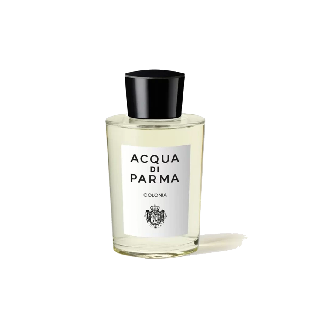 Bottle of Acqua Di Parma Colonia Eau de Cologne on a wooden surface with citrus fruits and floral accents around it.