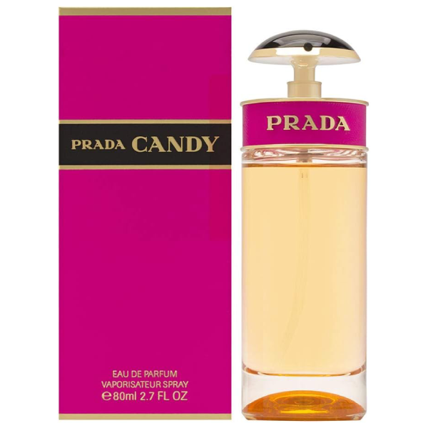 Prada Candy perfume bottle on a pink and gold background.