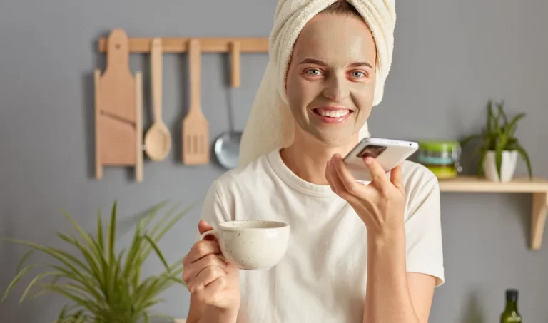 Beautiful woman enjoying coffee while wearing a facial mask.