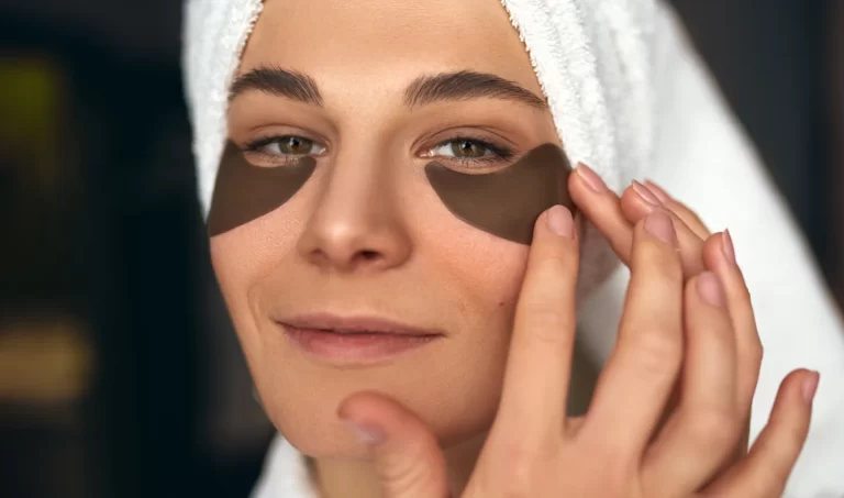 Elegant woman using gel under eye masks for skincare.