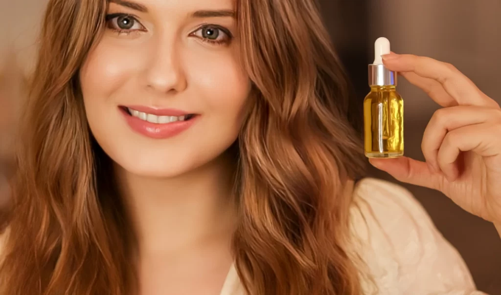 A beautiful woman holding a glass vial filled with natural facial oils, with sunlight streaming through the bottle.