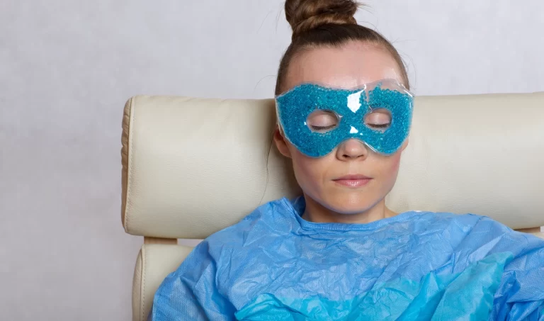 Young woman with captivating eyes demonstrating the application of cooling masks for under-eye puffiness