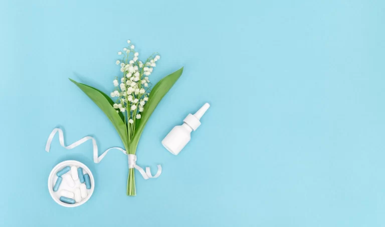 Image featuring flowers, a drop, and pills arranged against a blue background, symbolizing eczema treatment.