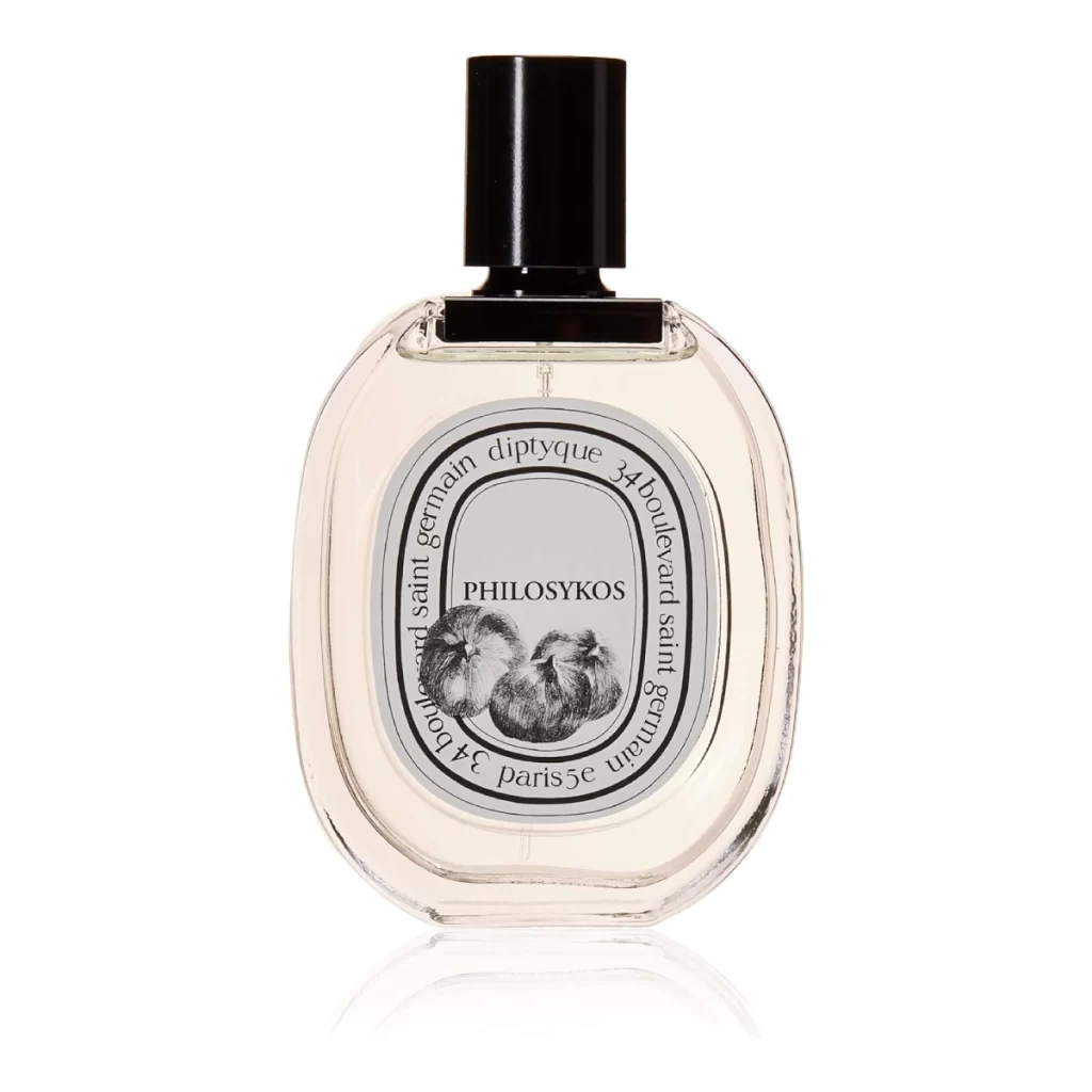 Diptyque Philosykos Eau de Toilette bottle elegantly positioned on a marble countertop, with fig leaves in the background