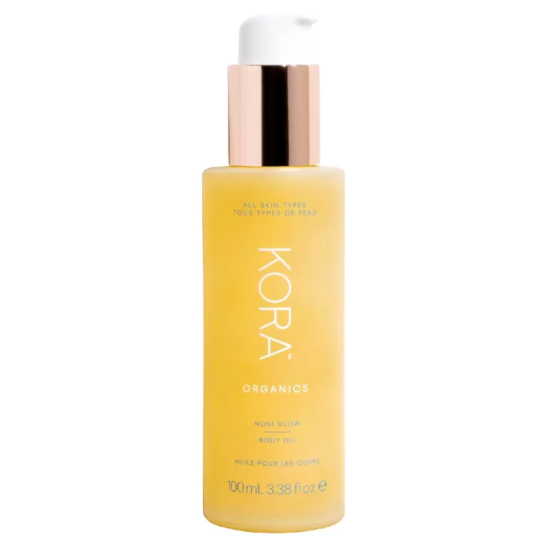 Elegant bottle of KORA Organics Noni Glow Body Oil displayed on a soft backdrop